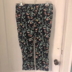 Ann Taylor Loft floral patterned pants on navy blue background.
